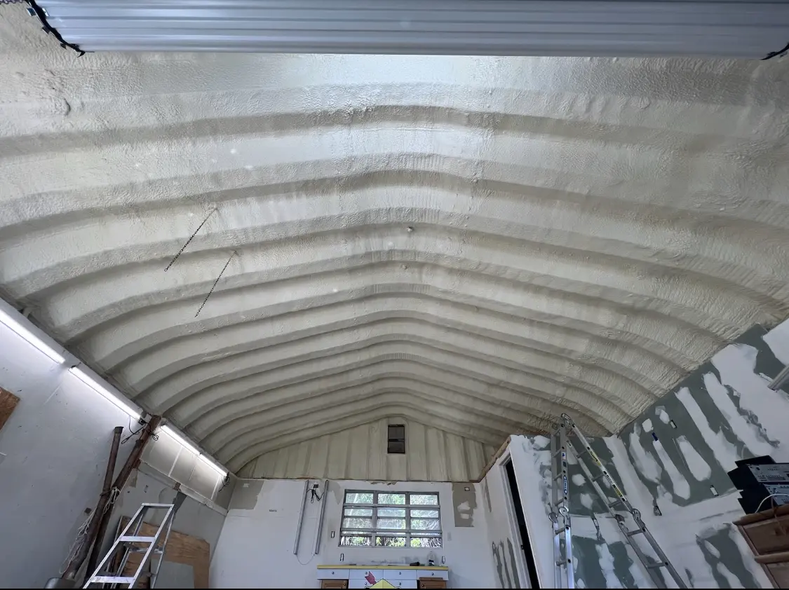 Spray polyurethane foam applied to the underside of a metal roof deck in North Oaks